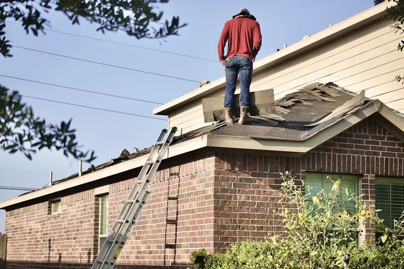Professional roofer working on a residential roof in Sea Pines Circle